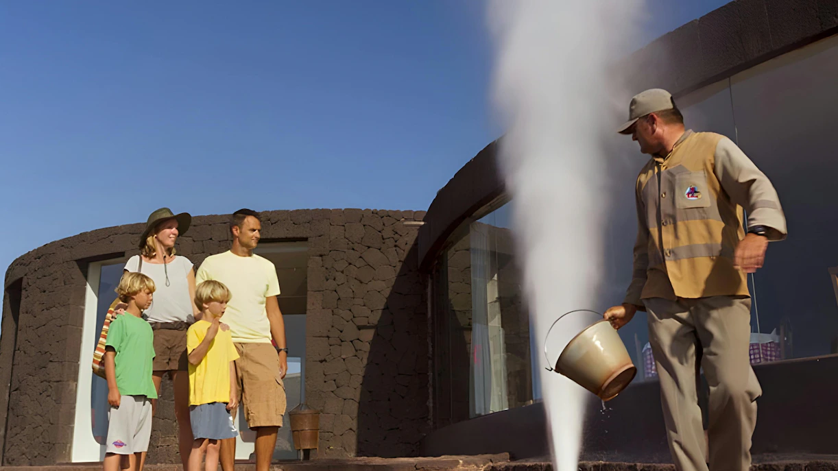Family observing geothermical water demonstration at Timanfaya National Park, Lanzarote.