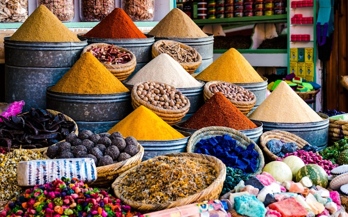 Spices in metal bins and baskets at a Marrakech souk.