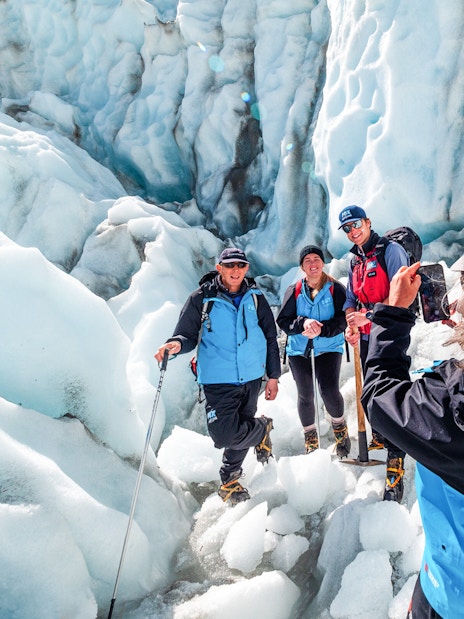 Hikers taking photos on Fox Glacier, New Zealand.