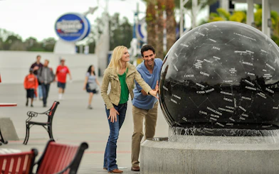 Visitors interacting with the Constellation Sphere at Kennedy Space Center.