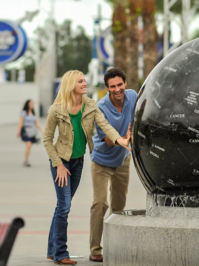 Visitors interacting with the Constellation Sphere at Kennedy Space Center.