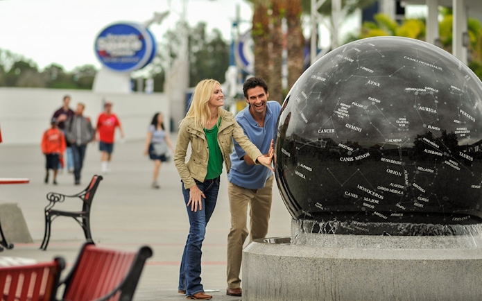 Visitors interacting with the Constellation Sphere at Kennedy Space Center.