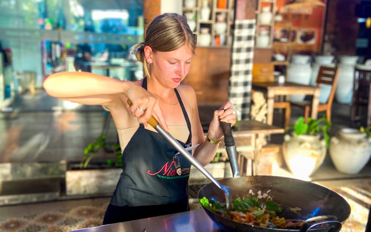 Participant cooking in Nia Balinese Cooking Class, Bali.