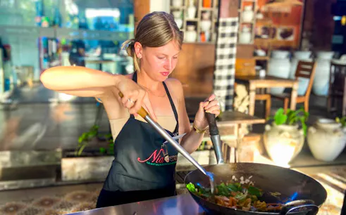 Participant cooking in Nia Balinese Cooking Class, Bali.