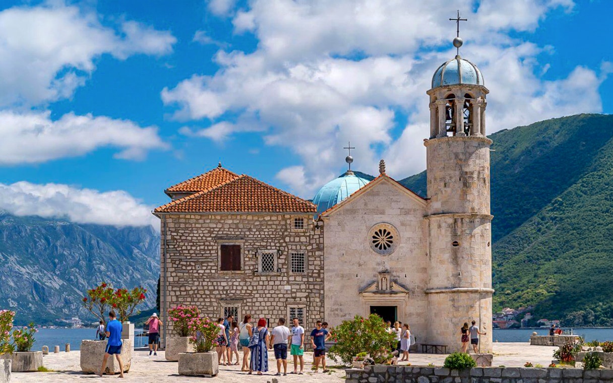 Our Lady of the Rocks church with tourists in Kotor Bay, Montenegro.