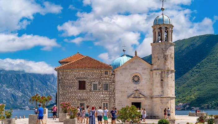Our Lady of the Rocks island with church in Kotor Bay, Montenegro, surrounded by blue waters.