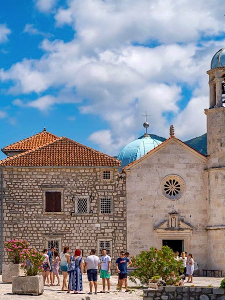 Our Lady of the Rocks church with tourists in Kotor Bay, Montenegro.