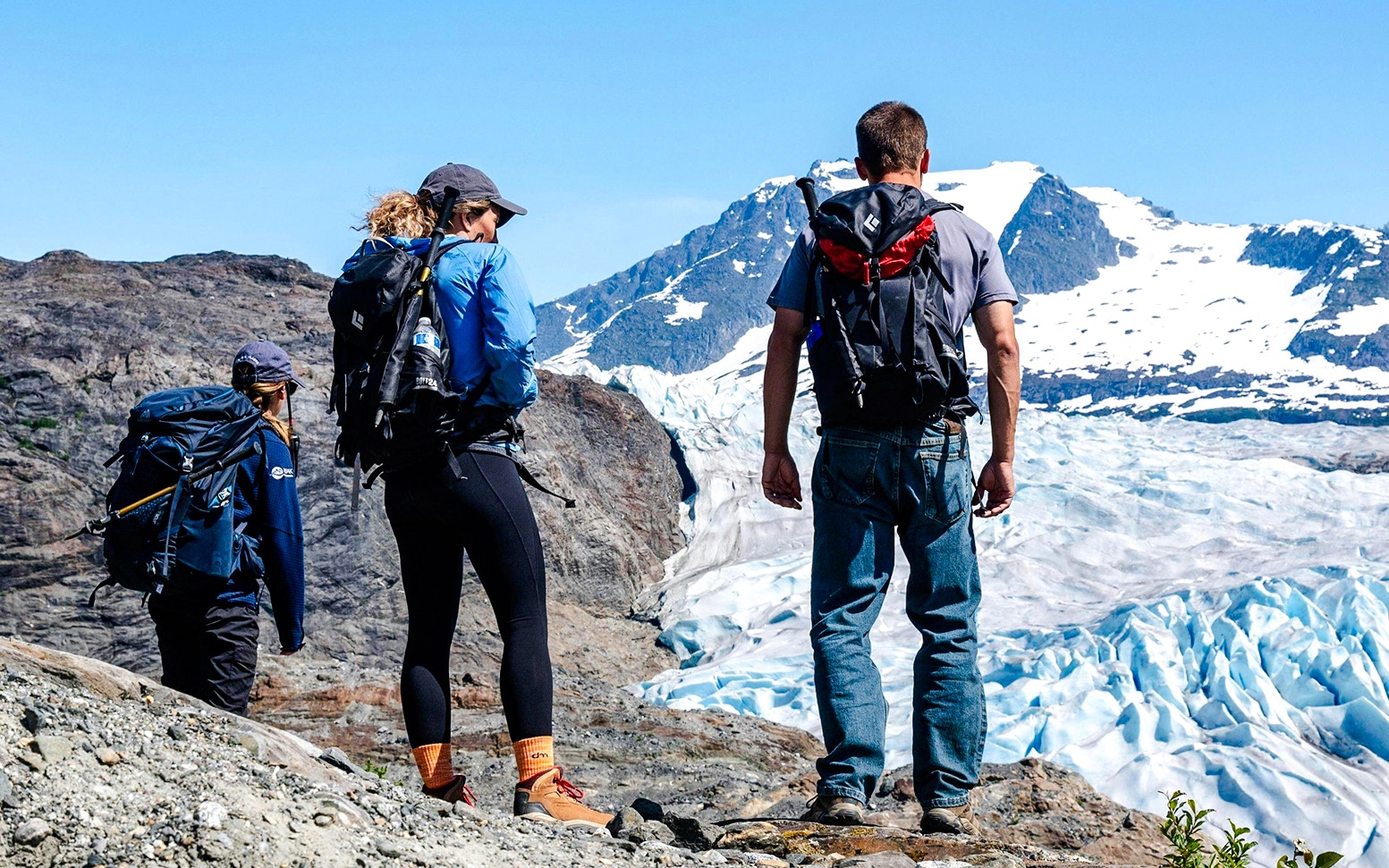 Hikers overlooking Mendenhall Glacier in Alaska.