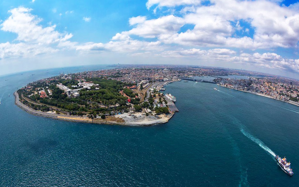 Aerial view of the Bosphorus Strait in Istanbul, Turkey, with a ferry crossing the water.