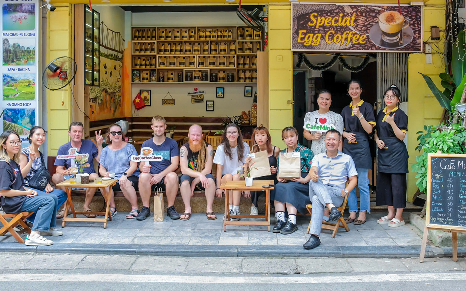 Group enjoying egg coffee at a Hanoi café during guided city tour.
