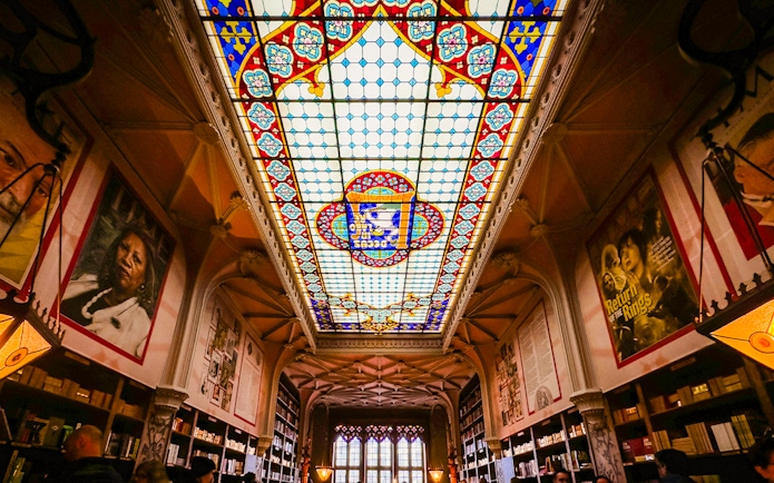 Lello Library stained glass ceiling with colorful patterns in Porto, Portugal.