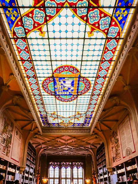 Lello Library stained glass ceiling with colorful patterns in Porto, Portugal.