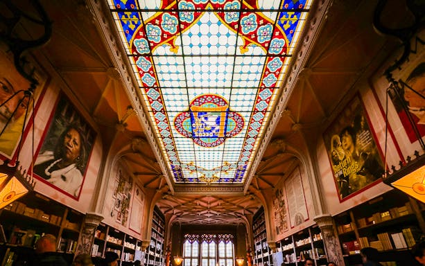 Lello Library stained glass ceiling with colorful patterns in Porto, Portugal.