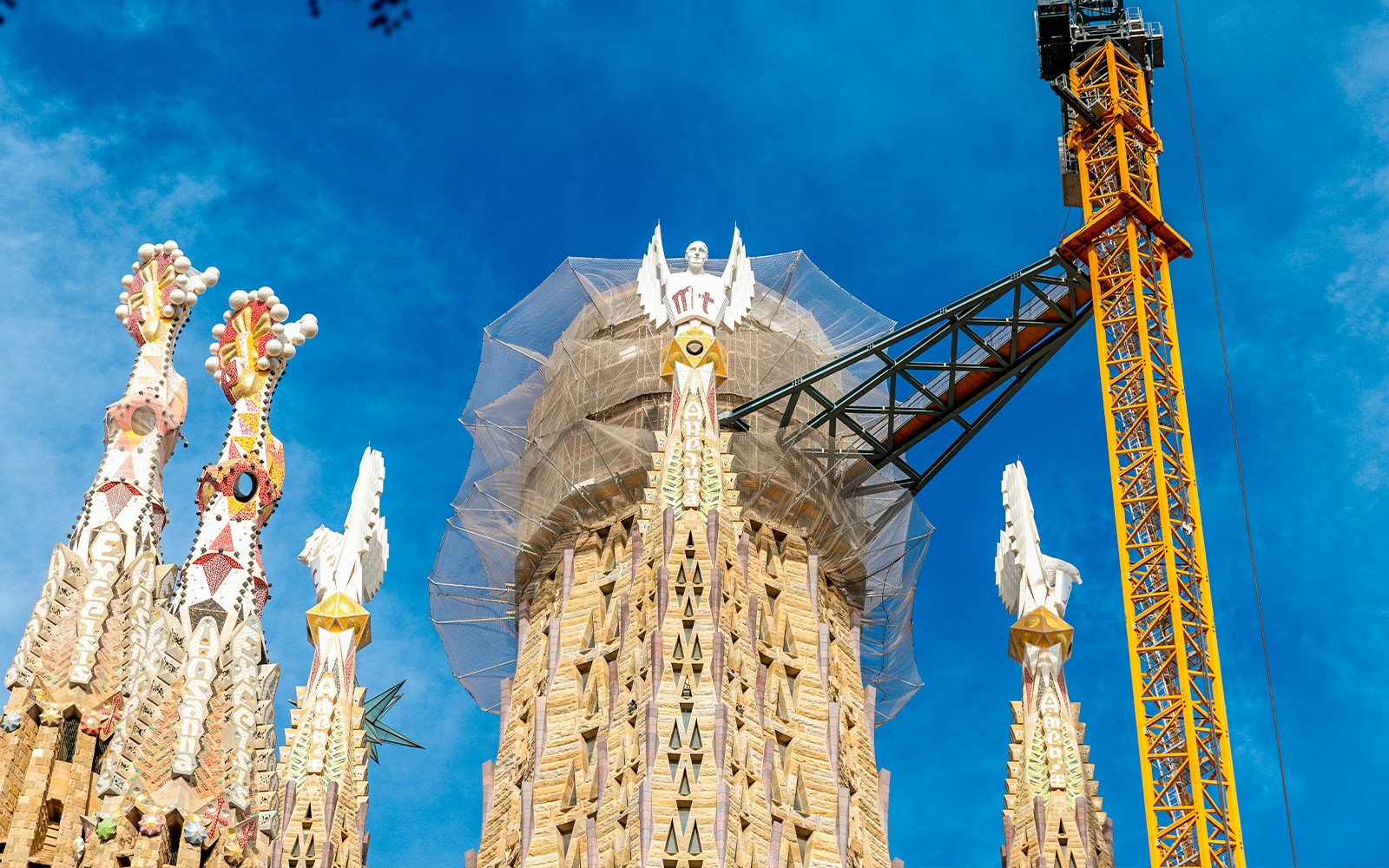 Sagrada Familia middle tower under construction with crane in Barcelona, Spain.
