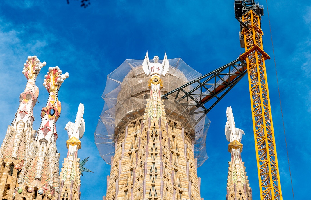 Sagrada Familia middle tower under construction with crane in Barcelona, Spain.