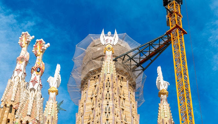 Sagrada Familia middle tower under construction with crane in Barcelona, Spain.