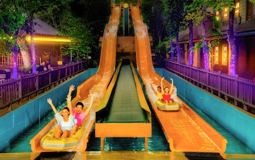 Visitors enjoying water slides at Sunway Lagoon's Christmas Night Park.