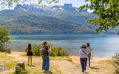 Travelers enjoying lake and mountain views along the Seven Lakes Route.