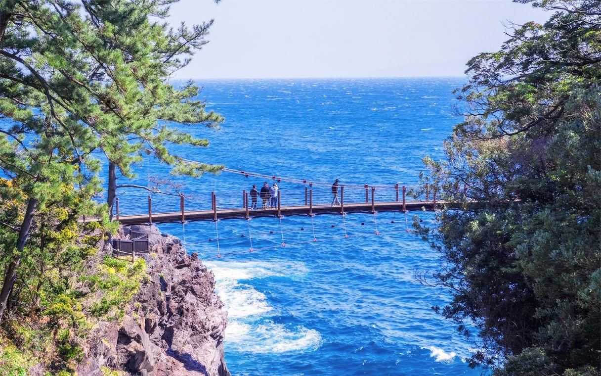 Kadowaki Suspension Bridge over blue ocean on Jogasaki Coast, Ito, Shizuoka, Japan.
