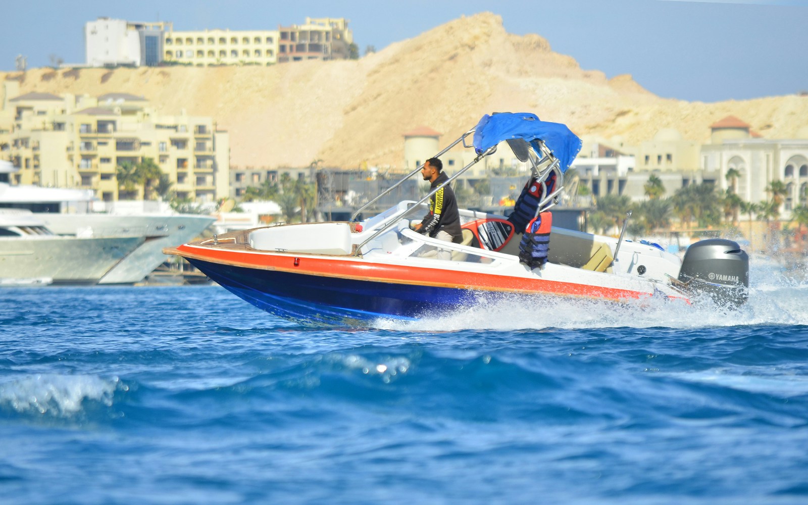 Private speedboat on the water near Dolphin House, suitable for up to six people.