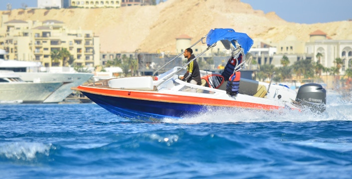 Private speedboat on the water near Dolphin House, suitable for up to six people.