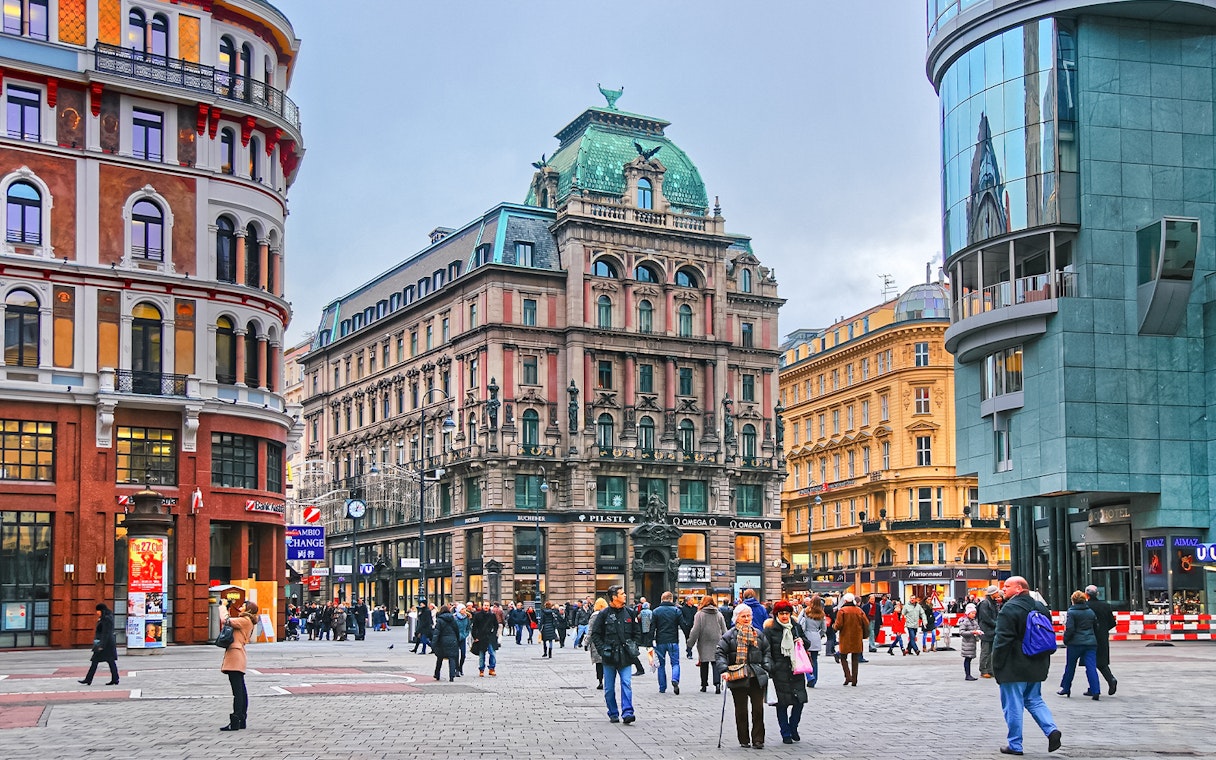 Pedestrians in Stephansplatz, Vienna, Austria, surrounded by historic and modern architecture.