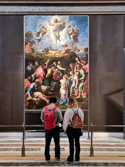 Visitors viewing Renaissance paintings in the Vatican Museum collection.