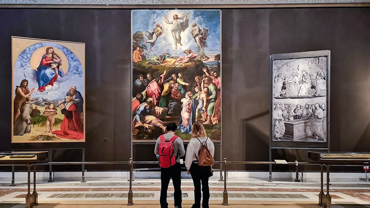 Visitors viewing Renaissance paintings in the Vatican Museum collection.
