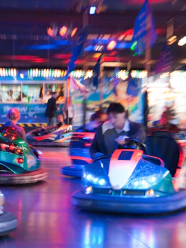 Bumper cars at Legend Heroes Park, Macau, with colorful lights and motion blur.