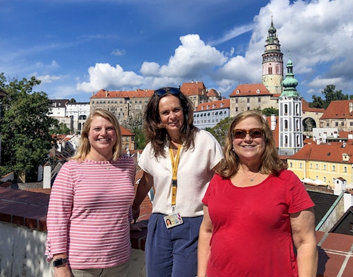 Tour guide leading tourists through historic Cesky Krumlov streets, Czech Republic.