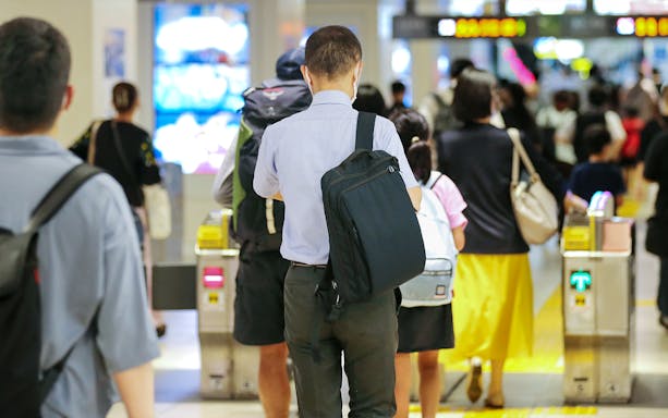 Crowd passing through ticket gates at Central Japan International Airport.