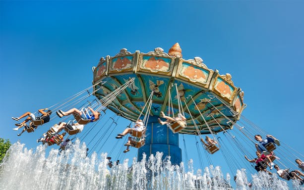 Swing ride at Phantasialand with people enjoying the attraction.