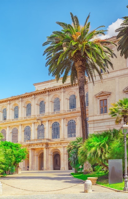 Barberini Palace facade with palm trees, Rome, Italy.