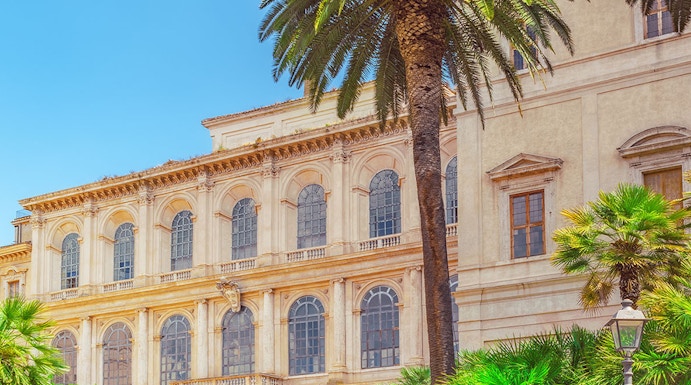 Barberini Palace facade with palm trees, Rome, Italy.