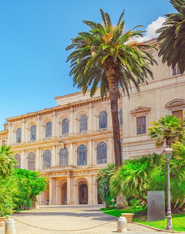 Barberini Palace facade with palm trees, Rome, Italy.