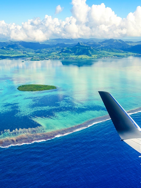 Seaplane view of Mauritius coastline and turquoise waters.