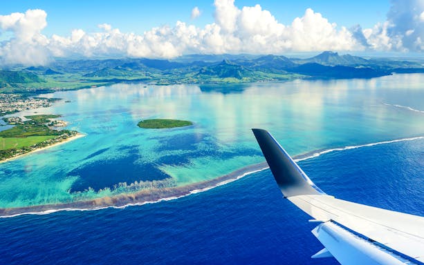 Seaplane view of Mauritius coastline and turquoise waters.