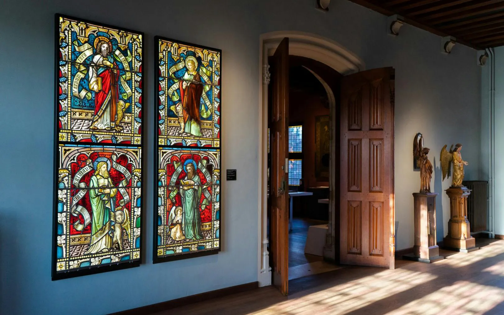 Stained glass windows and sculptures inside Gruuthusemuseum, Bruges.