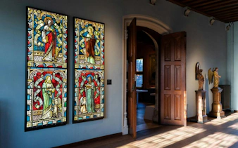 Stained glass windows and sculptures inside Gruuthusemuseum, Bruges.