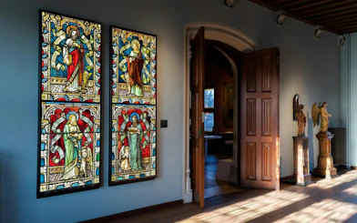 Stained glass windows and sculptures inside Gruuthusemuseum, Bruges.