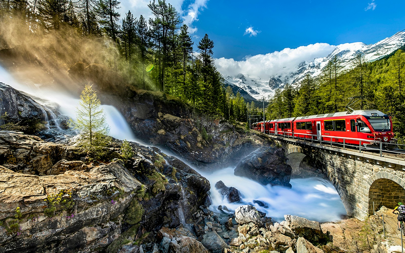 Bernina Express train traveling through Swiss Alps from Chur to Tirano.