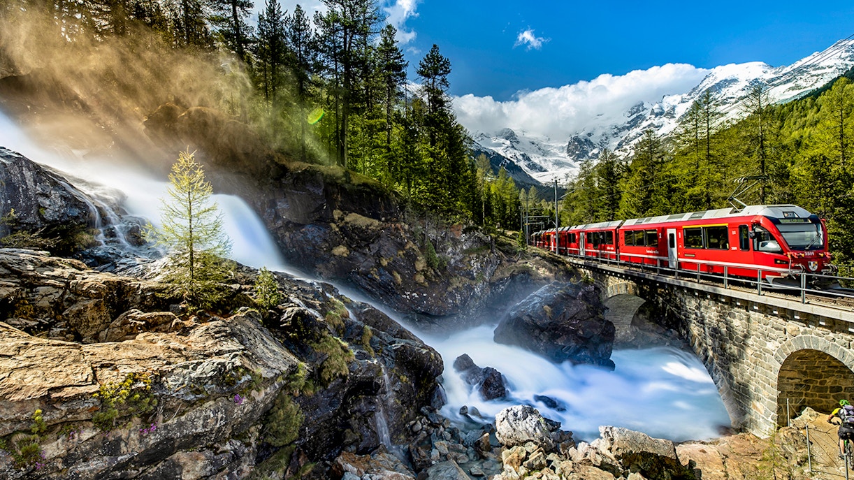 Bernina Express train traveling through Swiss Alps from Chur to Tirano.