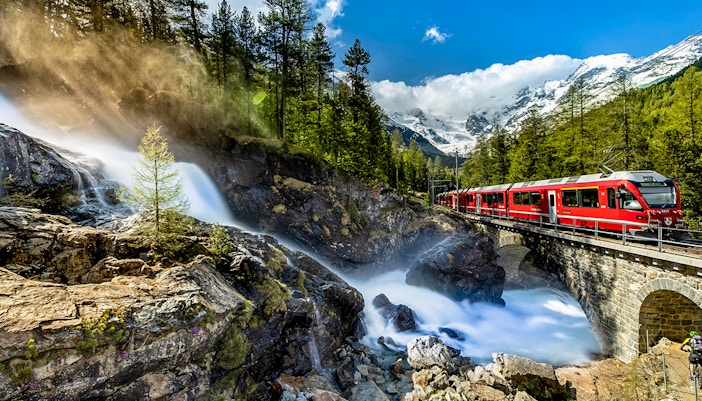 Bernina Express train traveling through Swiss Alps from Chur to Tirano.