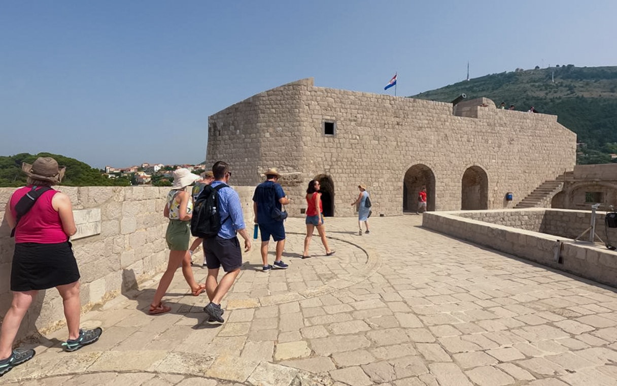 Guests walking along Dubrovnik's historic walls, exploring Game of Thrones filming location.