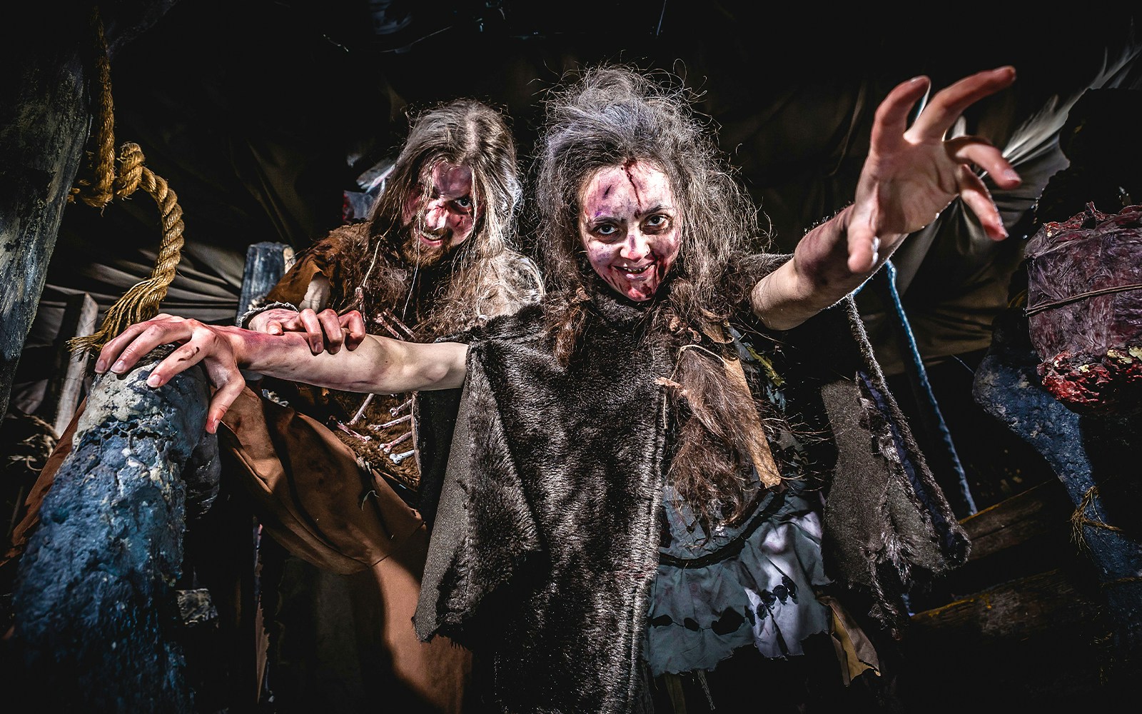 Actors portraying cannibals in the Cannibal Cave at Edinburgh Dungeon.