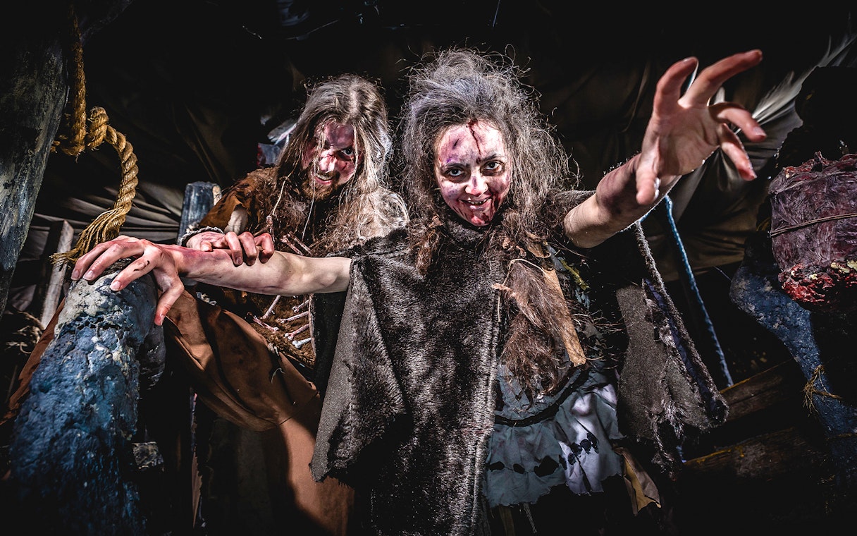 Actors portraying cannibals in the Cannibal Cave at Edinburgh Dungeon.