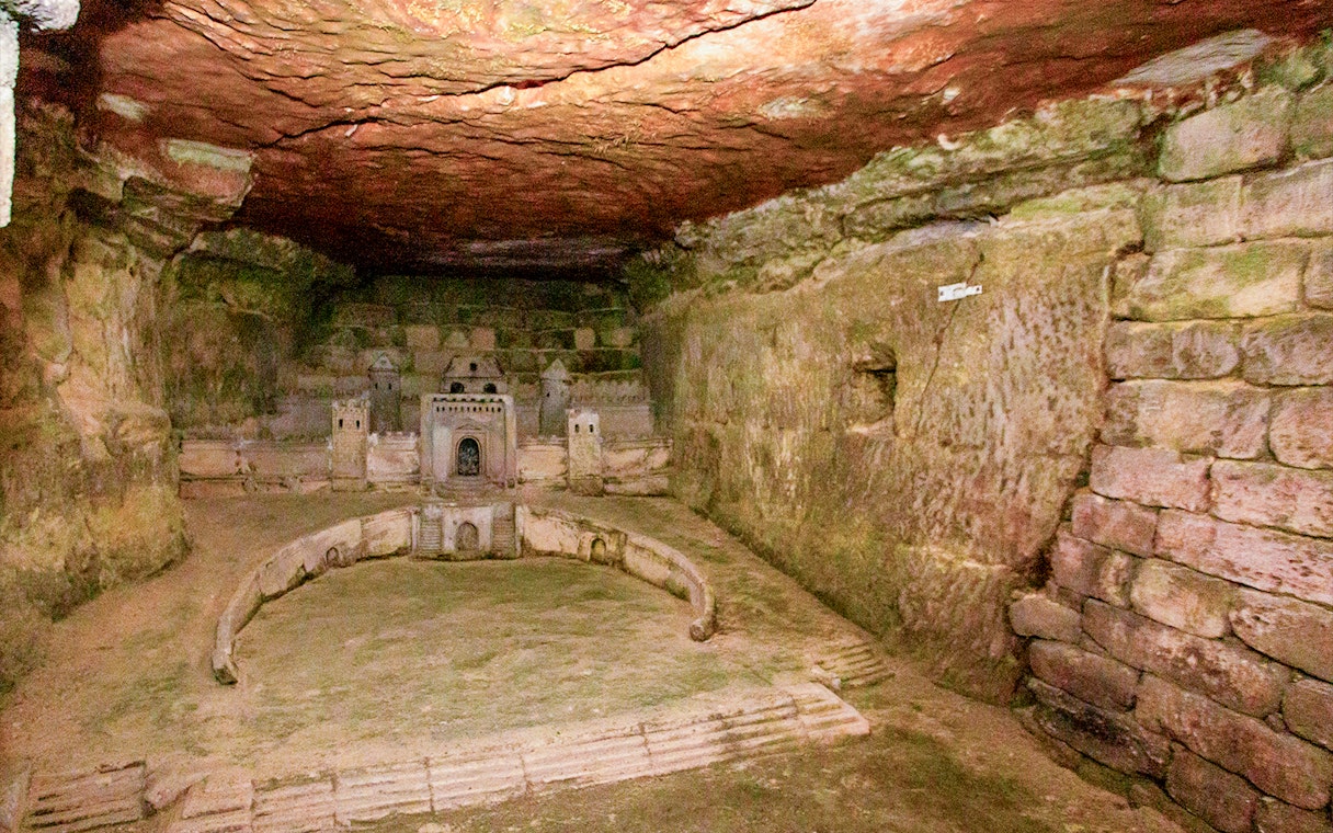Paris Catacombs model of Port-Mahon carved into limestone wall.