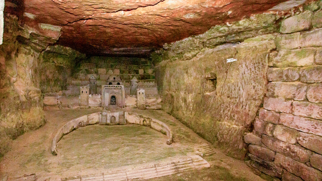 Paris Catacombs model of Port-Mahon carved into limestone wall.