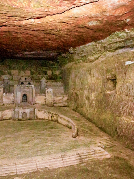Paris Catacombs model of Port-Mahon carved into limestone wall.