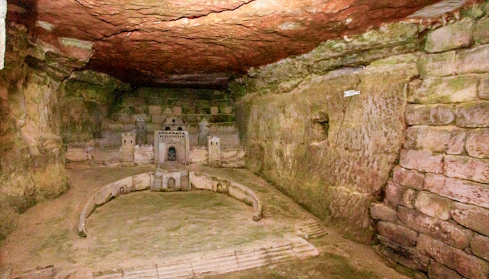 Paris Catacombs model of Port-Mahon carved into limestone wall.